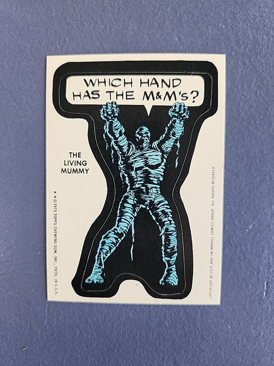 1975 TOPPS MARVEL COMIC STICKER, LIVING MUMMY, WHICH HAND HAS THE M&MS