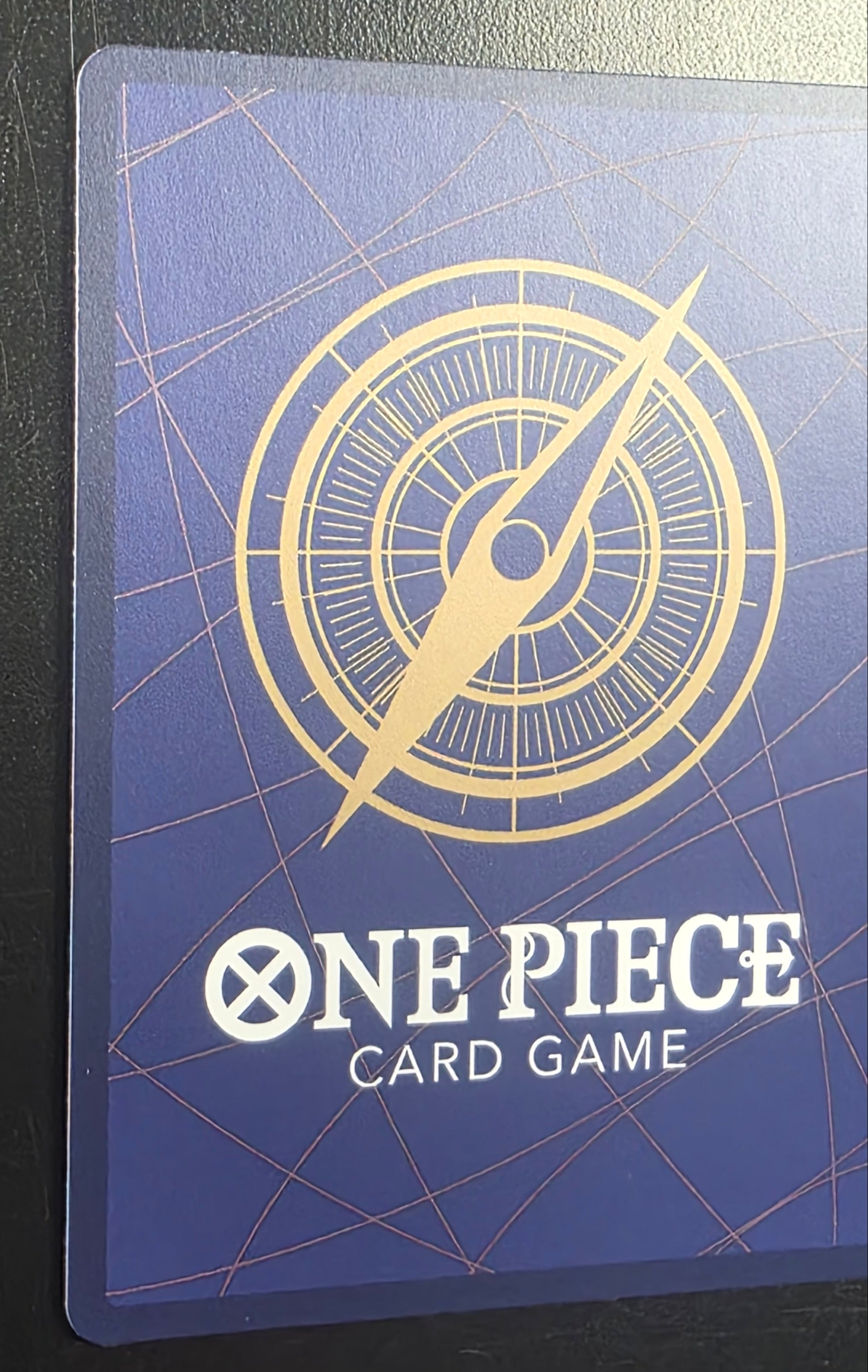 One Piece card game card with compass design on a blue background